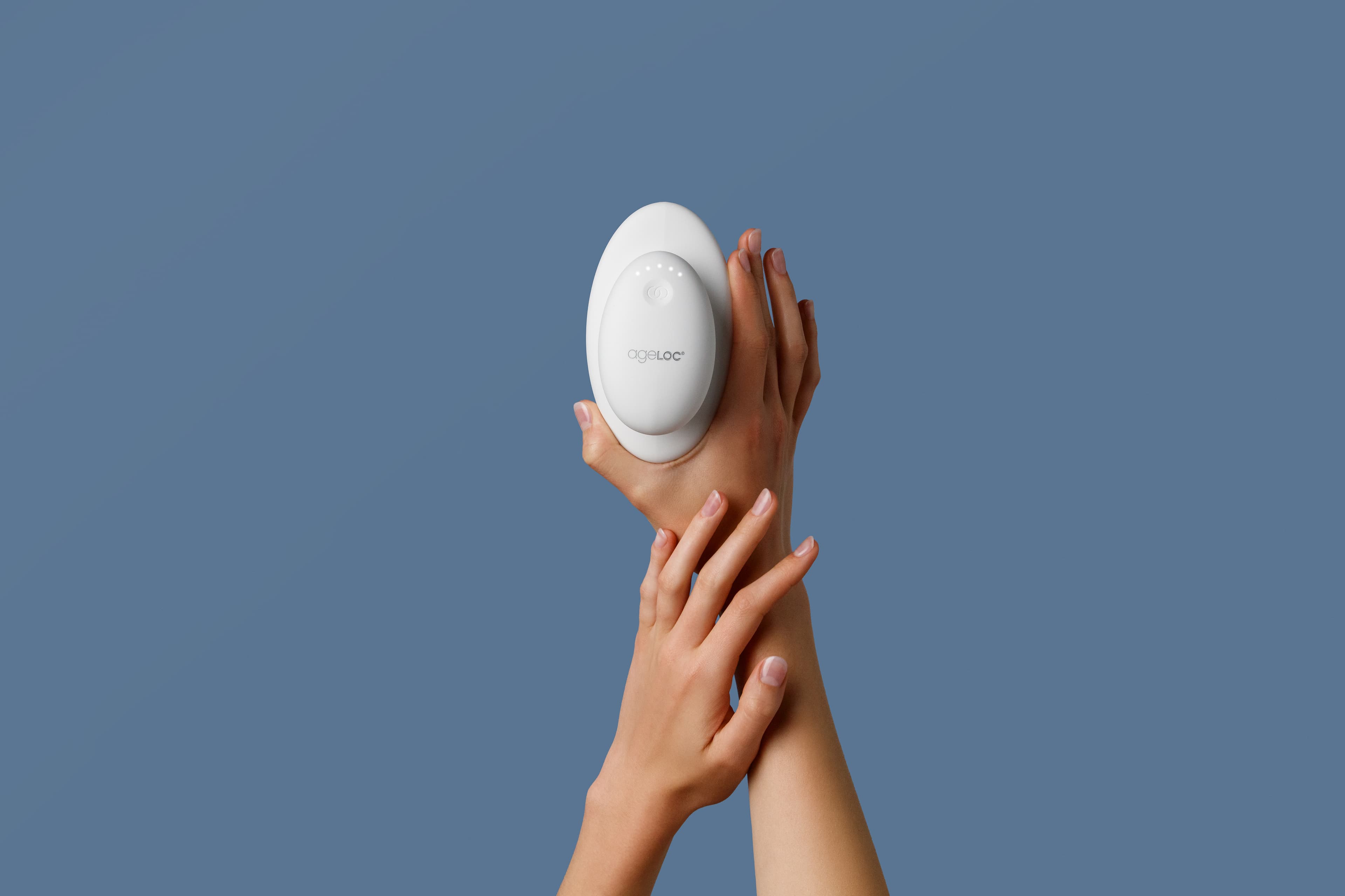 Hands holding the RenuSpa iO device